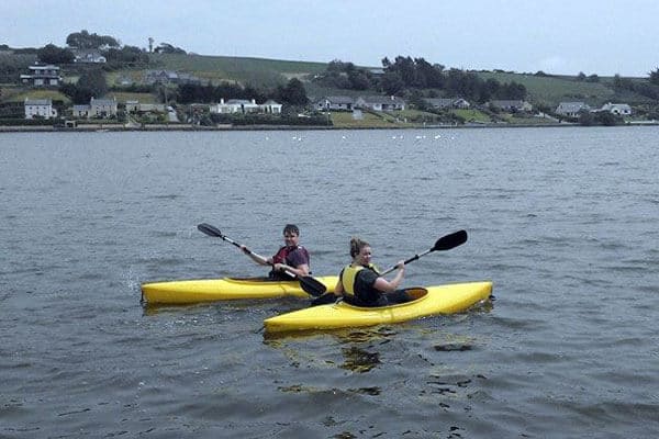 Two people kayaking in yellow kayaks