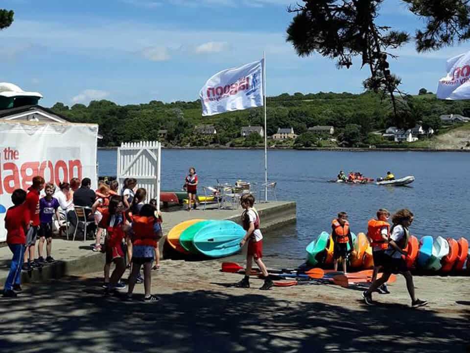 Children in lifejackets by the slipway, getting ready for water sports, highlighting outdoor activities in West Cork.