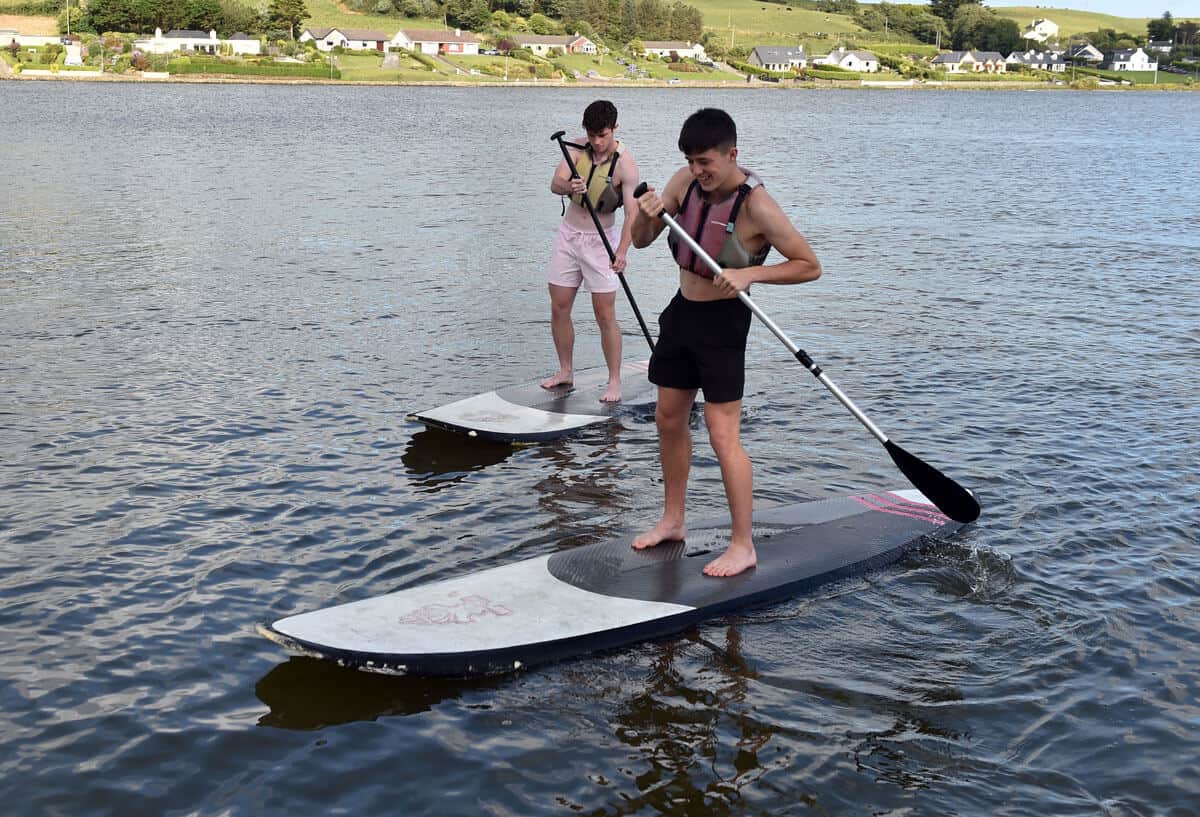 Two people using stand up paddle boards (SUP) at the Lagoon Activity Centre in Rosscarbery