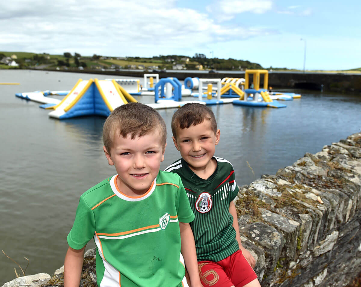Two boys and the Lagoon Activity Centre Water Park in the background