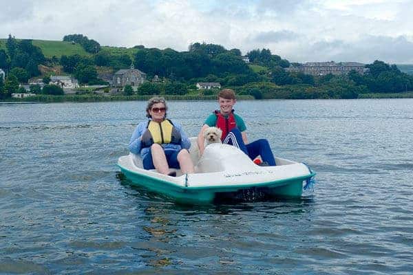 Two people enjoying rent a pedal boat in beautiful lagoon in West Cork