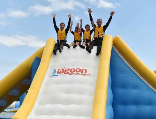 A family on the top of large slide in the inflatable water park